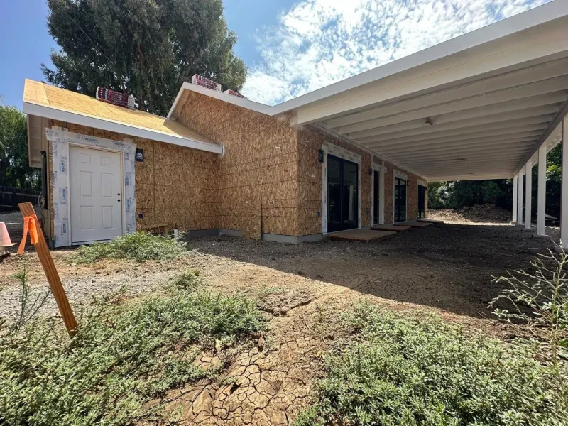 One of our home additions, framed and sheathed, with a covered patio
