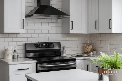 White kitchen with black island in Newark, photo 1
